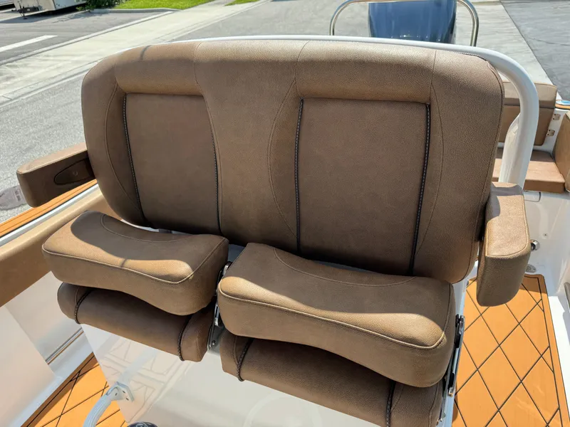 Slide: The Image of 2022 Sea Hunt Ultra 234 boat seat with brown cushioned design. - 42