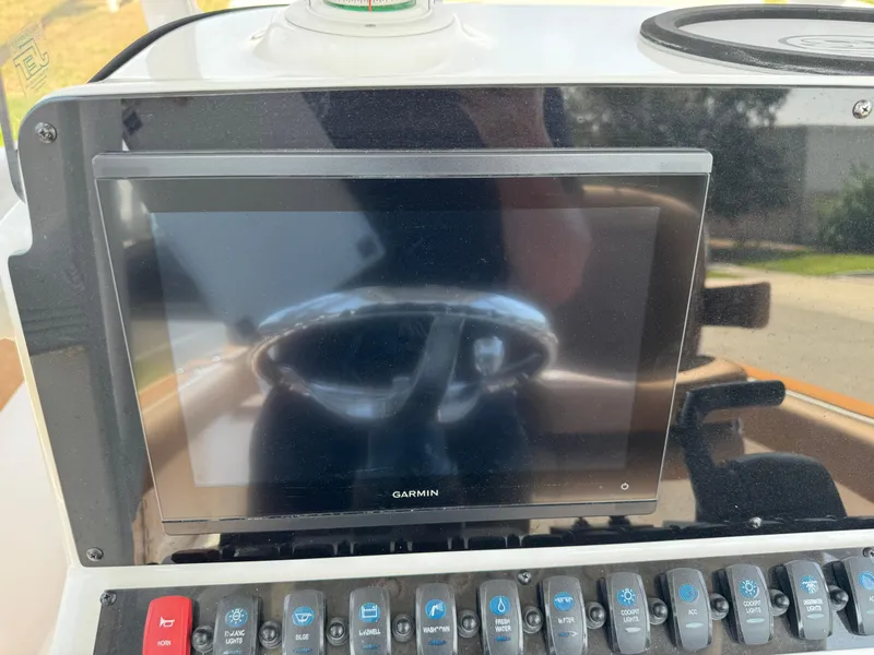 Slide: The Image of Dashboard of 2022 Sea Hunt Ultra 234 with Garmin display and control panel. - 47