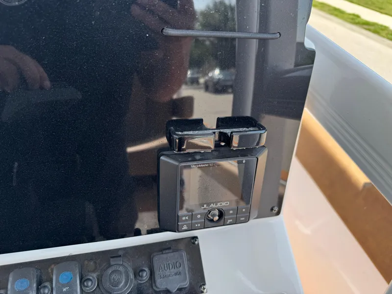 Slide: The Image of 2022 Sea Hunt Ultra 234 boat dashboard with audio control panel. - 48