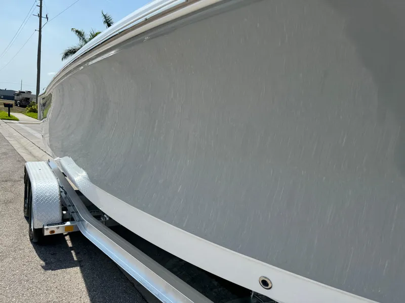 Slide: The Image of 2022 Sea Hunt Ultra 234 boat on trailer, side view, sunny day. - 5