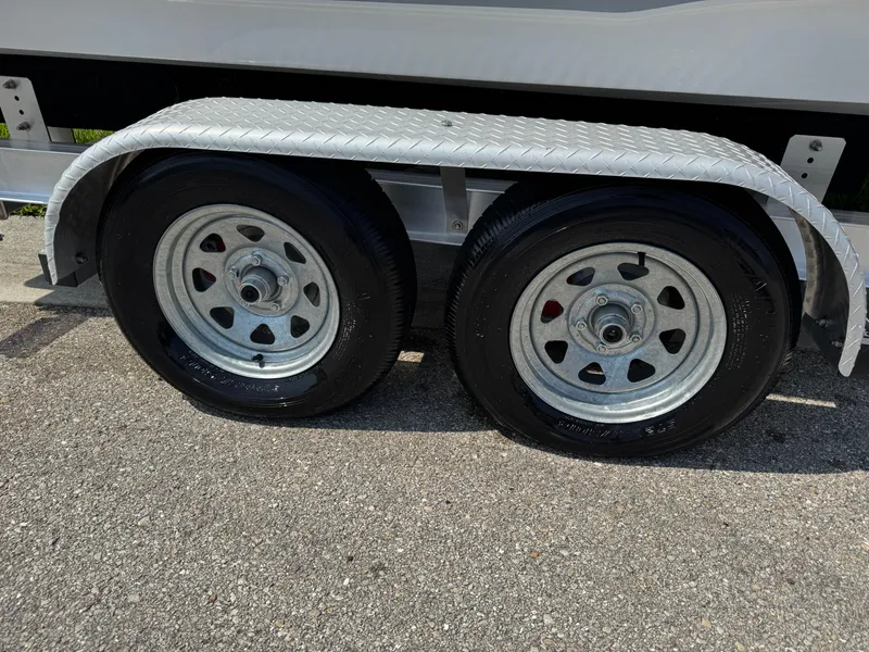 Slide: The Image of Trailer wheels of a 2022 Sea Hunt Ultra 234 boat on pavement. - 7