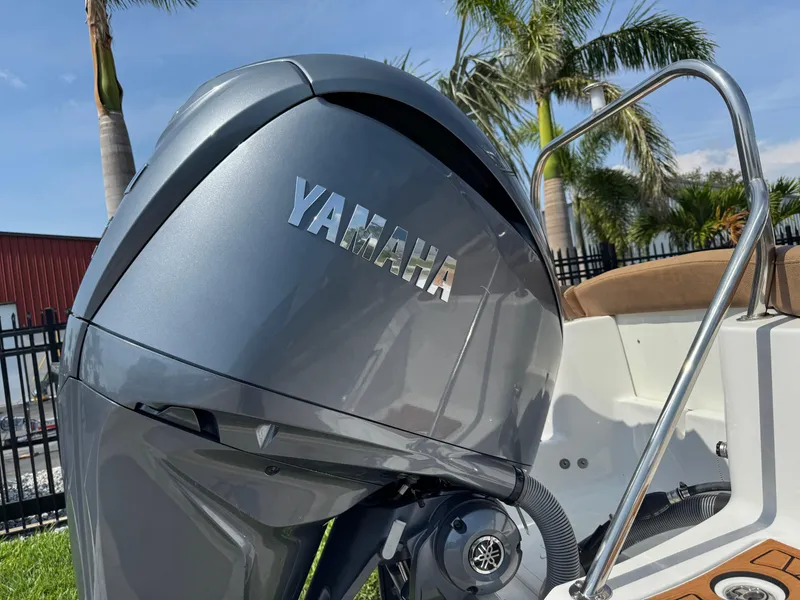 Slide: The Image of Yamaha outboard motor on 2022 Sea Hunt Ultra 234 boat, palm trees in background. - 8