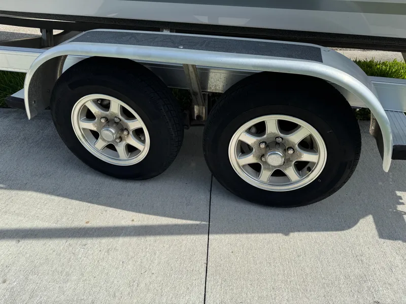 Slide: The Image of Trailer wheels for 2019 Sea Fox 206 Commander boat on concrete surface. - 19
