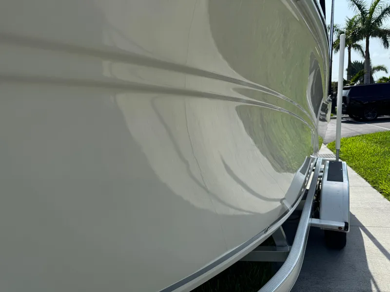 Slide: The Image of 2019 Sea Fox 206 Commander boat on trailer, side view with palm trees in background. - 22