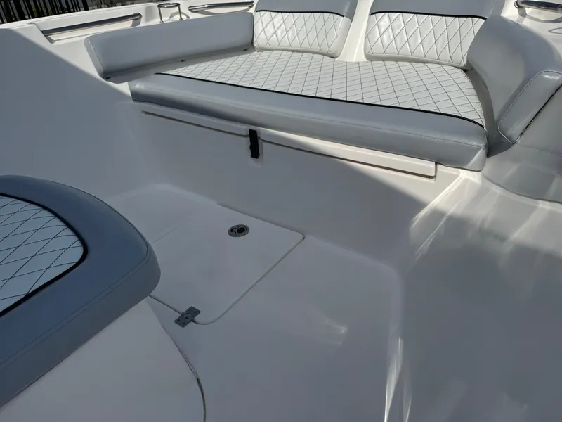 Slide: The Image of 2019 Sea Fox 206 Commander boat interior with cushioned seating and storage compartment. - 28