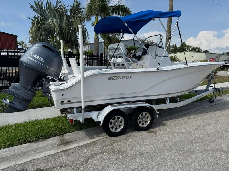 Slide: The Image of 2019 Sea Fox 206 Commander boat with Yamaha engine on trailer, blue canopy. - 3