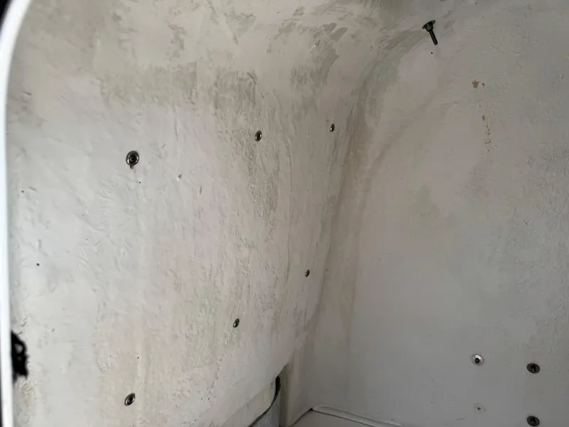 Slide: The Image of Interior view of a 2019 Sea Fox 206 Commander boat, showing textured white walls with screws. - 42