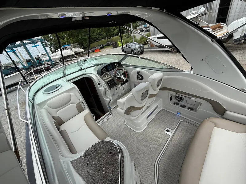 Slide: The Image of 2023 Crownline 264 CR boat interior with modern seating and dashboard. - 14