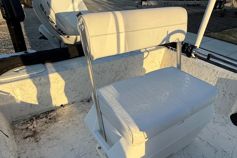 Slide: The Image of 2023 Coastal Skiff 171 boat seat with white cushioned bench and backrest. - 7