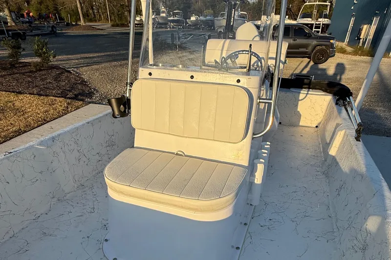 Slide: The Image of 2023 Coastal Skiff 171 boat interior with seating and steering console. - 9