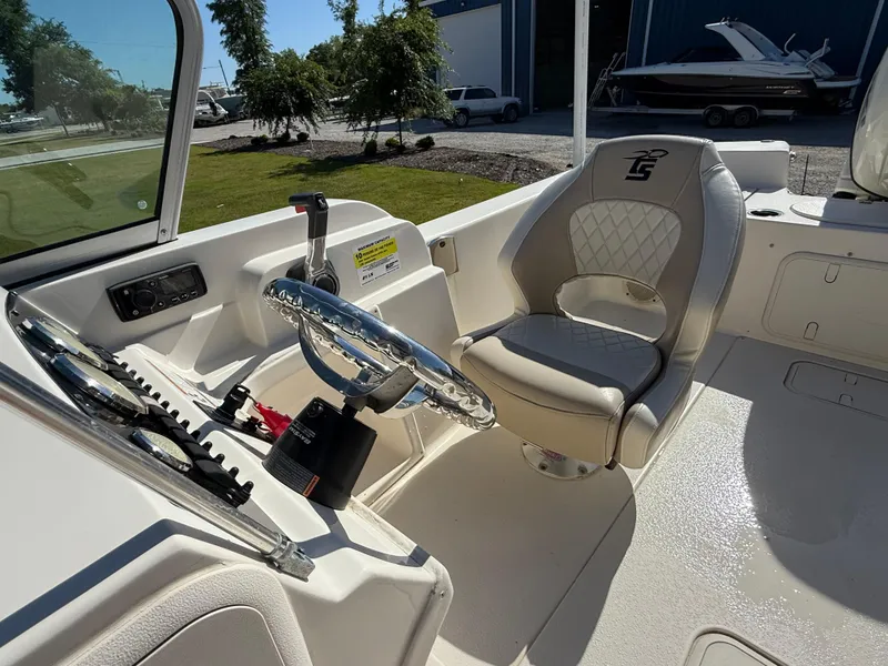 Slide: The Image of 2020 Carolina Skiff 21LS Dual Console interior with steering wheel and captain's chair. - 11
