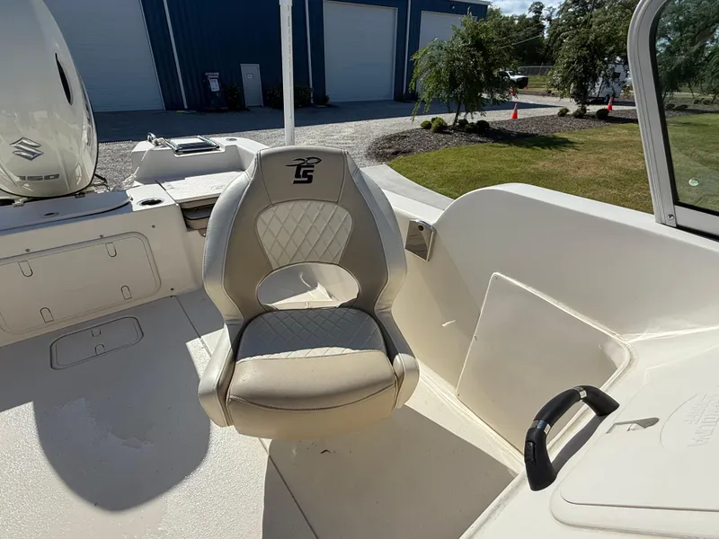 Slide: The Image of 2020 Carolina Skiff 21LS Dual Console boat interior with cushioned seating and console view. - 12