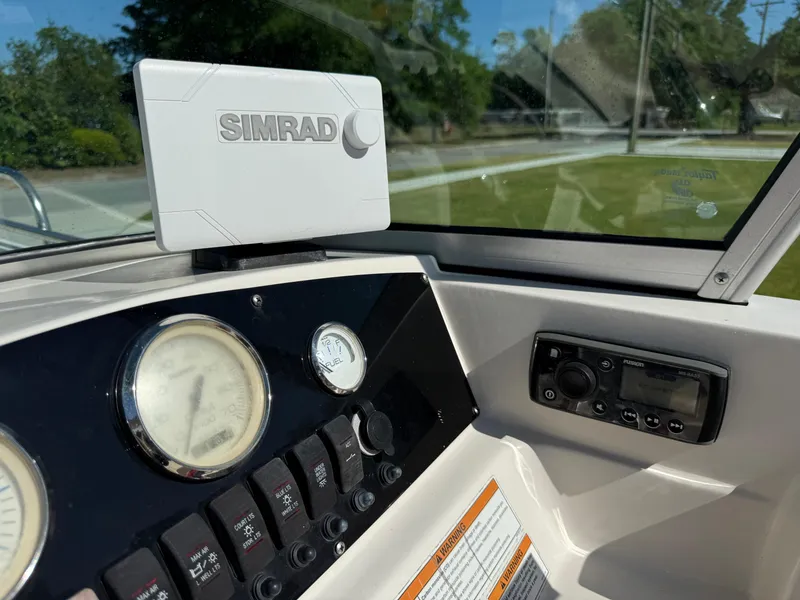 Slide: The Image of 2020 Carolina Skiff 21LS Dual Console dashboard with Simrad navigation system and gauges. - 14