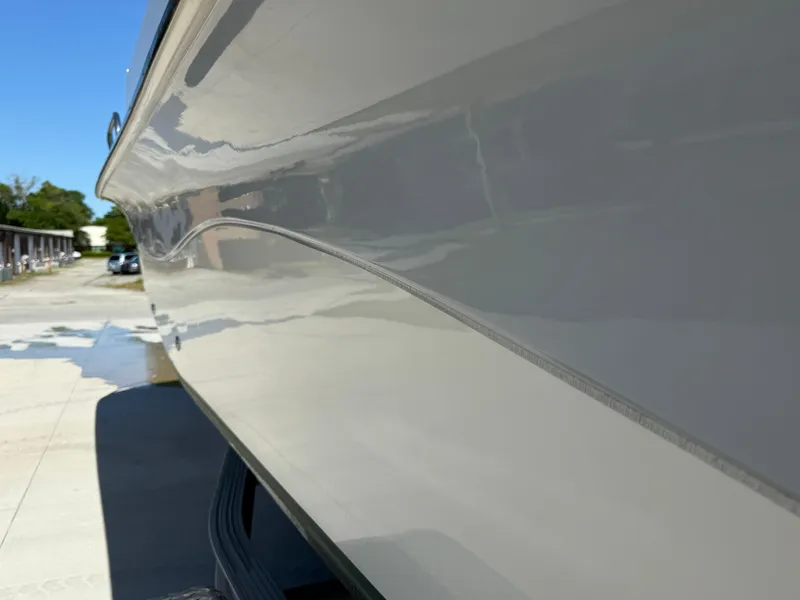Slide: The Image of 2020 Carolina Skiff 21LS Dual Console boat side view, showcasing sleek design and smooth finish. - 15