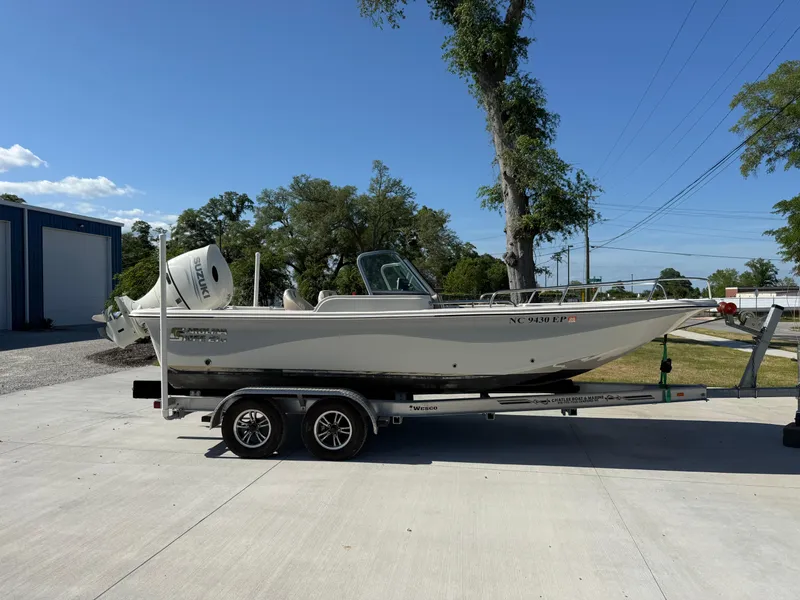 Slide: The Image of 2020 Carolina Skiff 21LS Dual Console boat on trailer, parked outdoors. - 3