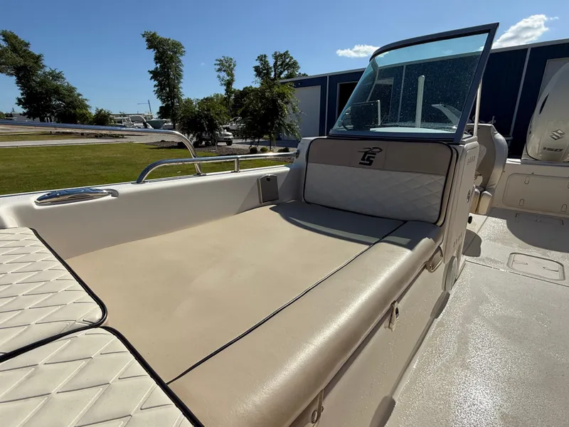 Slide: The Image of 2020 Carolina Skiff 21LS Dual Console boat with beige seating and windshield, outdoors. - 5