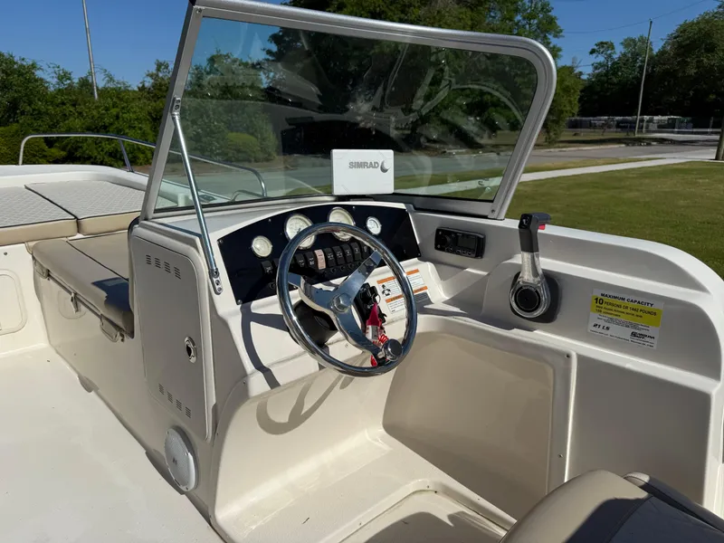 Slide: The Image of 2020 Carolina Skiff 21LS Dual Console boat interior with steering wheel and dashboard. - 6