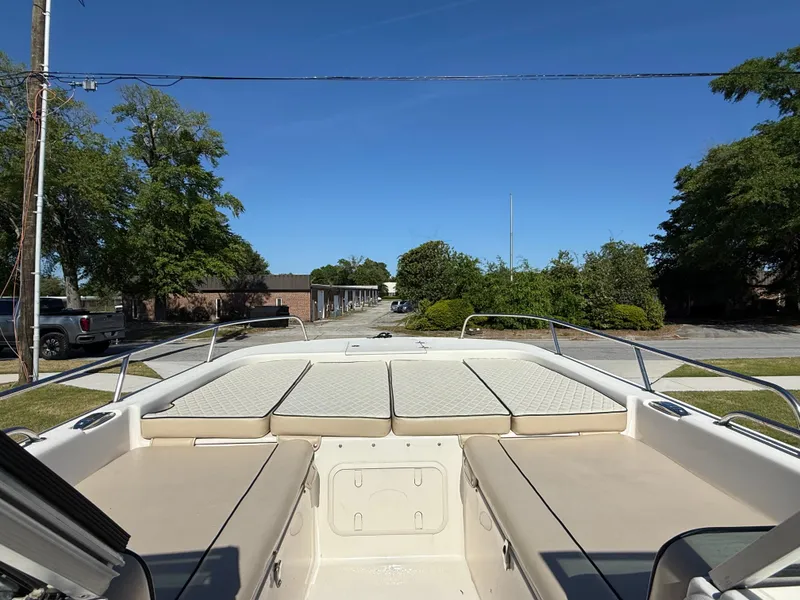 Slide: The Image of 2020 Carolina Skiff 21LS Dual Console boat with spacious seating and clear blue sky. - 8