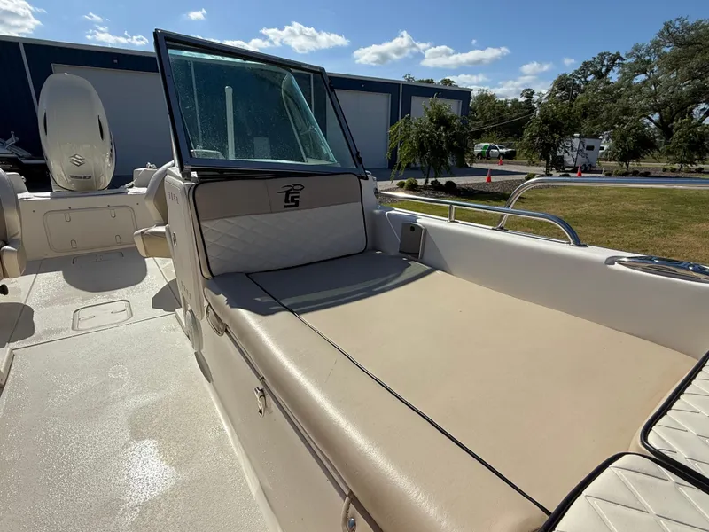 Slide: The Image of 2020 Carolina Skiff 21LS Dual Console boat with beige seating and windshield, outdoors. - 9