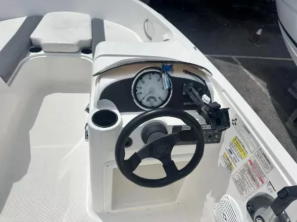 Slide: The Image of 2015 Bayliner Element E180 boat cockpit with steering wheel and instrument panel. - 12