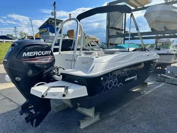 Slide: The Image of 2015 Bayliner Element E180 boat with Mercury outboard motor, docked outdoors. - 4