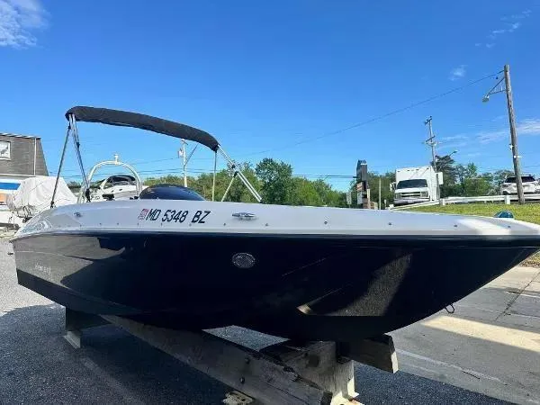 Slide: The Image of 2015 Bayliner Element E180 boat on trailer under clear blue sky. - 6