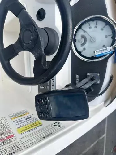 Slide: The Image of 2015 Bayliner Element E180 dashboard with steering wheel and gauges. - 7