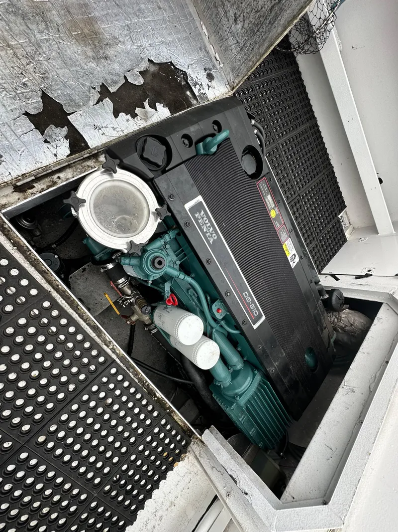 Slide: The Image of 1995 Almar 26 Sounder boat docked, featuring a white deck and black railings. - 11