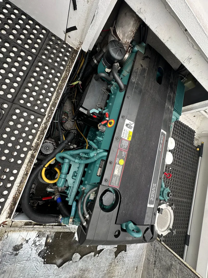 Slide: The Image of 1995 Almar 26 Sounder boat roof with radar and railing, docked near a concrete fence. - 12