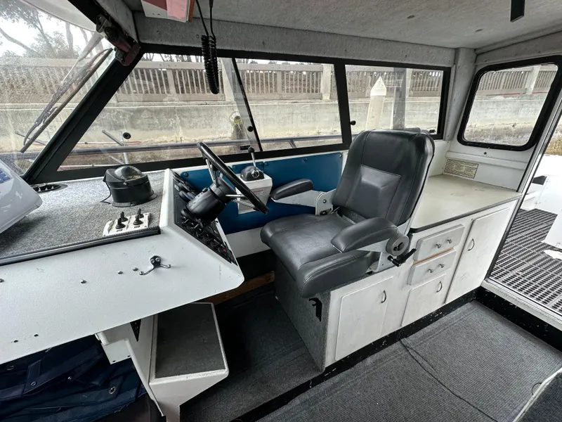 Slide: The Image of 1995 Almar 26 Sounder boat deck, docked, with storage compartment and non-slip flooring. - 14