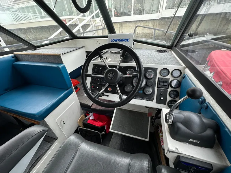 Slide: The Image of 1995 Almar 26 Sounder boat docked, featuring cabin entrance and safety equipment. - 15