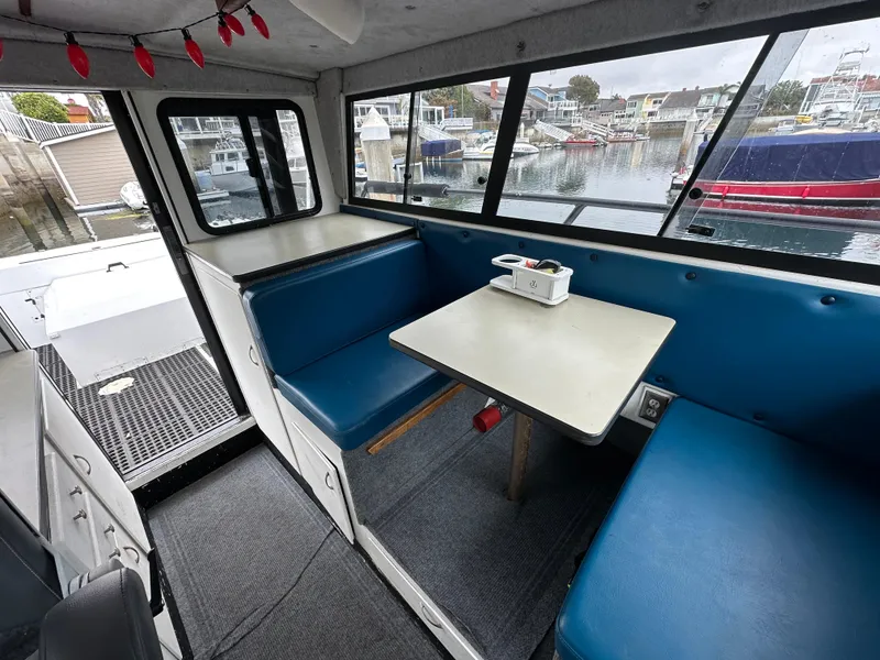 Slide: The Image of Interior of a 1995 Almar 26 Sounder boat with seating and steering area. - 18