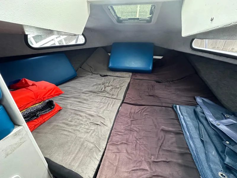 Slide: The Image of Interior cabin of a 1995 Almar 26 Sounder boat with bedding and cushions. - 24