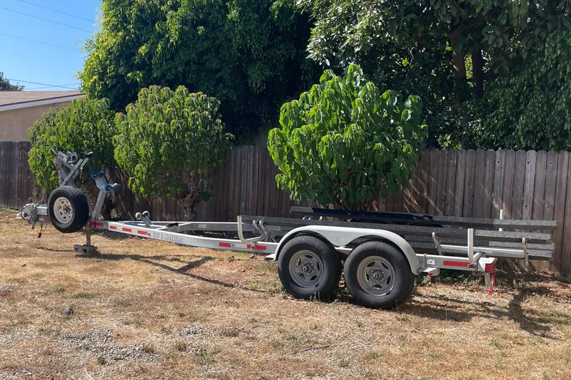 Slide: The Image of Trailer for 1995 Almar 26 Sounder, parked on grass near wooden fence. - 27