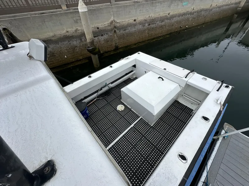 Slide: The Image of 1995 Almar 26 Sounder boat docked at a marina under cloudy skies. - 9