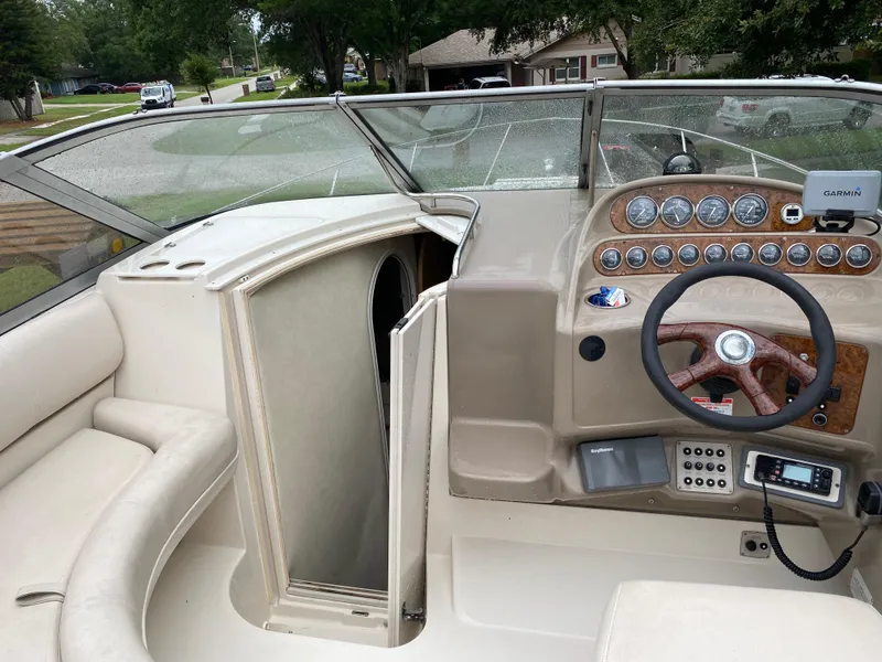 Slide: The Image of 1998 Regal 292 Commodore boat interior with steering wheel and open cabin door. - 11