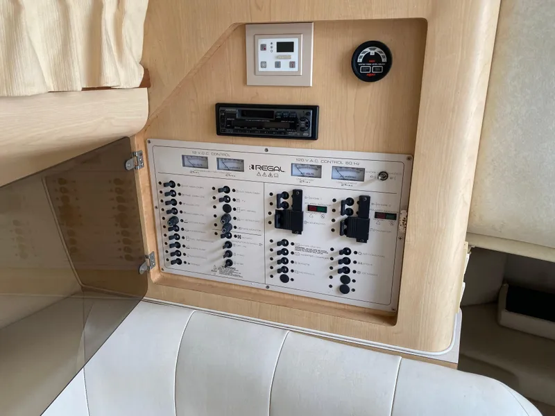 Slide: The Image of 1998 Regal 292 Commodore control panel with switches and gauges in cabin interior. - 13