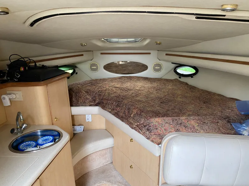 Slide: The Image of Interior cabin of 1998 Regal 292 Commodore boat with bed and kitchenette. - 15