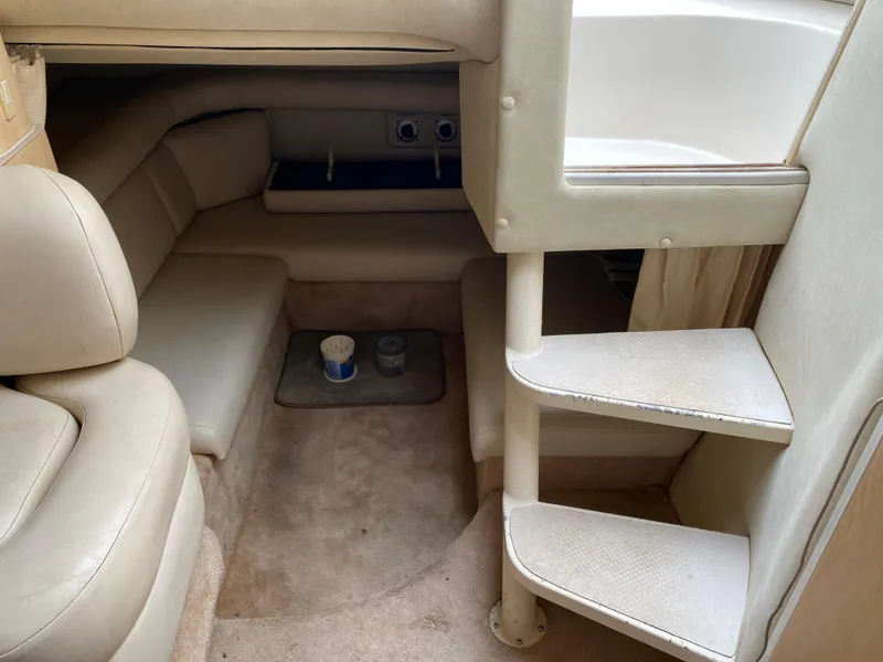Slide: The Image of Interior of 1998 Regal 292 Commodore boat with beige seating and carpeted stairs. - 20