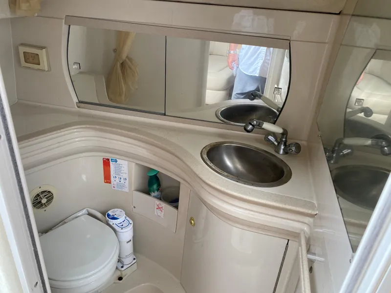 Slide: The Image of 1998 Regal 292 Commodore boat bathroom with sink, mirror, and toilet. - 21