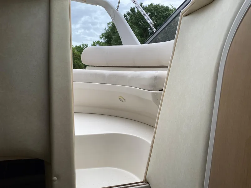 Slide: The Image of 1998 Regal 292 Commodore boat interior with white seating and sleek design. - 22