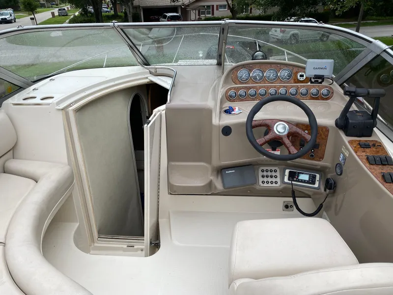 Slide: The Image of 1998 Regal 292 Commodore boat cockpit with steering wheel and control panel. - 24