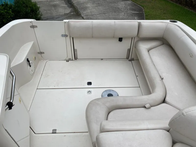 Slide: The Image of 1998 Regal 292 Commodore boat interior with white seating and spacious layout. - 26