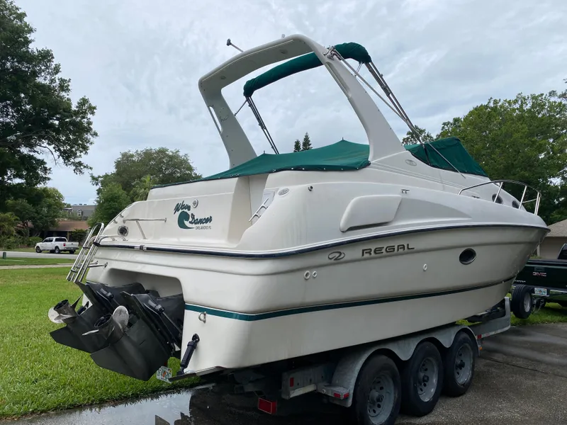 Slide: The Image of 1998 Regal 292 Commodore boat on trailer, parked outdoors. - 5
