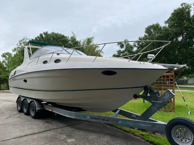 Slide: The Image of 1998 Regal 292 Commodore boat on trailer, parked outdoors, overcast sky. - 8