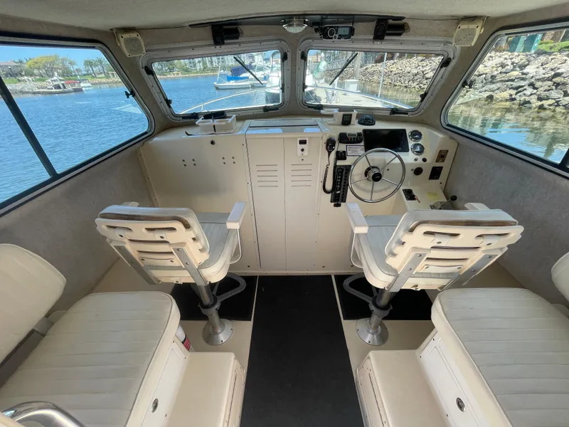 Slide: The Image of Interior of 2008 Parker 2520 XL Sport Cabin boat with helm and seating. - 18