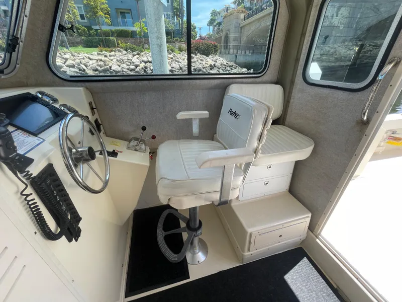 Slide: The Image of 2008 Parker 2520 XL Sport Cabin interior with steering wheel and captain's chair. - 19