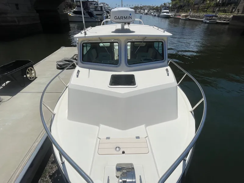 Slide: The Image of 2008 Parker 2520 XL Sport Cabin boat docked, featuring Garmin equipment. - 2