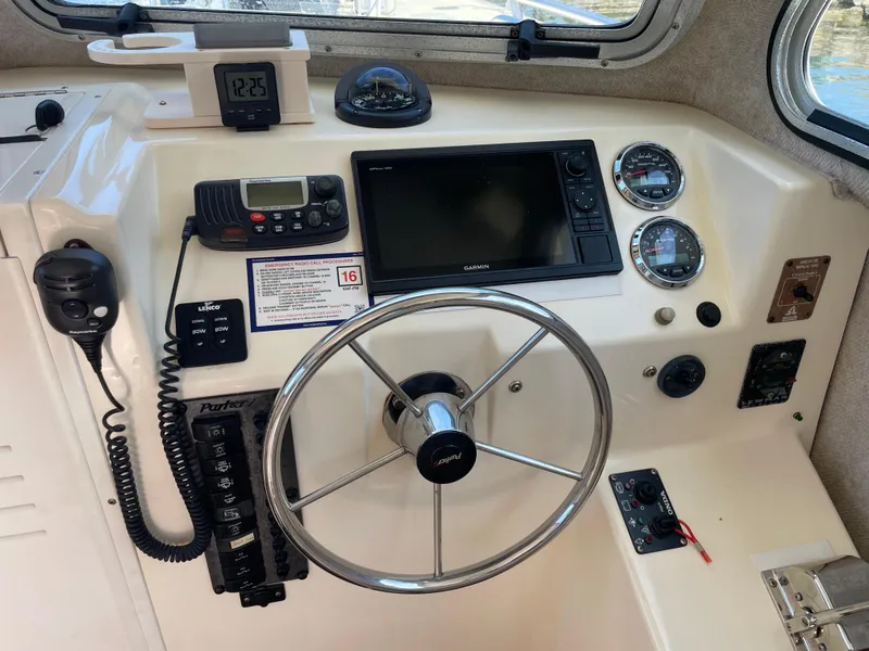 Slide: The Image of 2008 Parker 2520 XL Sport Cabin helm with steering wheel, gauges, and navigation equipment. - 21