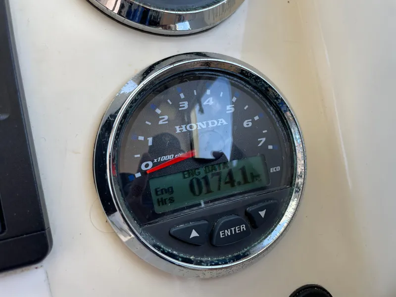Slide: The Image of Honda engine gauge displaying 174.1 hours on a 2008 Parker 2520 XL Sport Cabin boat. - 23